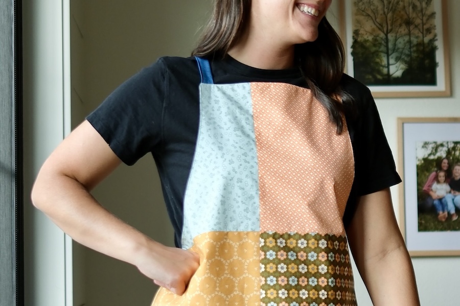 A sown Apron made of mix and matched quadrants of multi colored fabric